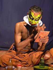 Kathakali dancer applying make-up in Kochi, Kerala, India.