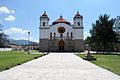 Church of San Bartolo with remains of pyramids to the left