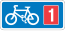 Rectangular, blue traffic sign with a white bicycle symbol and a red square with the number 1 in it.