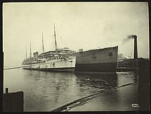 Cedric shortly after her launch. SS Britannic is seen laid up alongside her. Britannic (13603625213).jpg