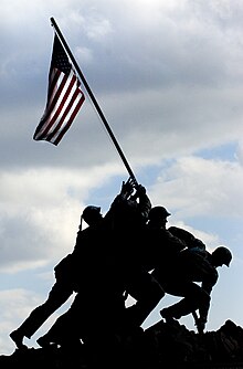 US Navy 081110-N-5549O-080 The U.S. national flag waves graciously from the Iwo Jima memorial during a wreath laying ceremony in honor of the 233rd Marine Corps birthday at the Marine Corps War Memorial.jpg