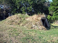 Small house built into small, grassy hill