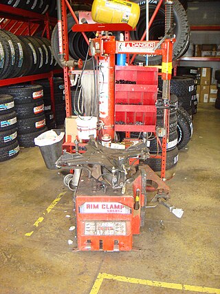 <span class="mw-page-title-main">Tire changer</span> Machine used to help tire technicians dismount and mount tires with automobile wheels