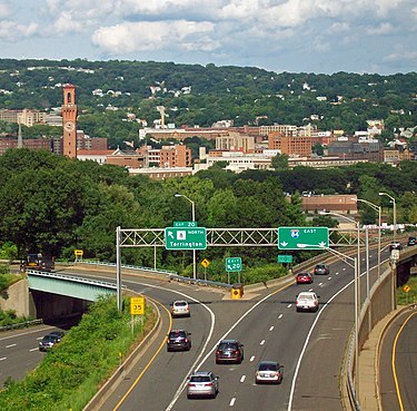 Interstate 84 approaching downtown Waterbury from the west, with the tower of Union Station prominent