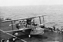 A Walrus lands on a Royal Navy carrier in the Indian Ocean, after rescuing under fire a pilot shot down while attacking Japanese positions on the Nicobar Islands Walrus carrier landing.jpg