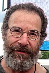 Mandy Patinkin looking towards the camera.