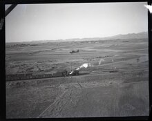 MARINE GRASSHOPPER PLANE of Major General Louis E. Woods First Marine Aircraft Wing flies low over a train carrying vitally needed coal between Tangshan and Tianjin. Planes patrol the tracks for breaks carrying mail and passengers at the same time. 127-N-226561.tif