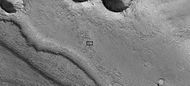 Close-up of channel within larger channel, as seen by HiRISE under HiWish program The existence of the smaller channel suggests water went through the region at least two times in the past. The black box represents the size of a football field. Some parts of the surface would be difficult to walk on with the many small hills and depressions.