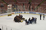 Michigan posing with the GLI banner after winning the 2015 tournament