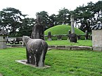 Stone statues and other monuments around a royal tomb