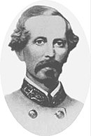 Black and white oval-shaped photo of a man with a moustache and goatee. He wears a gray military uniform.