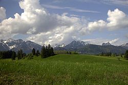 The Bavarian Alps rise from the green hills of the Molasse basin. The hills consist of tilted molasse beds, erosional material transported from the mountains into their foreland. Bavarian Alps 2002.jpg