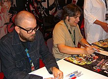 Voltron comics creators Brian Smith and Jacob Chabot signing Voltron posters at the Viz Media booth at the 2011 New York Comic Con. 10.16.11BrianSmithJacobChabotByLuigiNovi1.jpg