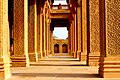 Some monuments feature corridors with roofs supported by intricately carved sandstone.