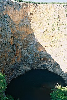 Sinkhole Depression or hole in the ground caused by collapse of the surface into an existing void space