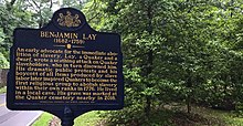 This sign is just outside the Abington Quaker Meeting house, where Benjamin Lay and Sarah Lay are buried. The sign reads: An early advocate for the immediate abolition of slavery. Lay, a Quaker and a dwarf, wrote a scathing attack on Quaker slaveholders, who in turn disowned him. His dramatic public protests and his boycott of all items produced by slave labor later inspired Quakers to become the first religious group to abolish slavery within their own ranks in 1776. He lived in a local cave. His grave was marked at the Quaker cemetery nearby in 2018.