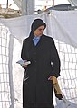 A Haredi woman wearing a black headscarf with padding at the hairline