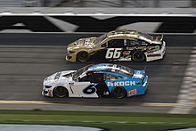 Hill in his No. 66 racing Ryan Newman in the 2020 Daytona 500. Both drivers made headlines that weekend. Ryan newman timmy hill (49562464727).jpg