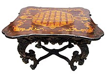 Table with marquetry top (as evidenced by cracking joints on left and right of top, but having wood grain carry on to both cleats indicating the surface is veneered) Mihailo Obrenovic, Prince of Serbia Sto kneza mikhaila.jpg