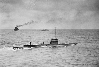 The battlecruiser Australia and a River-class destroyer (background) rendezvous with the submarine AE1 (foreground) in September 1914 AE1 off Rabaul.jpg