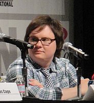 A brown-haired man wearing glasses