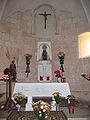 A simple decorated cloth covering a simple altar