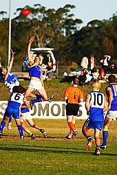 Two rucks contest the bounce in a suburban western Sydney AFL game between the East Coast Eagles AFC and Campbelltown Kangaroos AFC Ar contesting-web.jpg