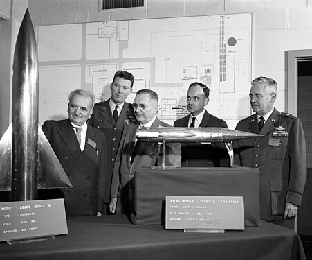 Theodore von Kármán inspecting two of the models used in wind tunnels. U.S. Air Force photographer, restored by Chris Woodrich