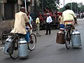 Transporting milk churns in Kolkata, India