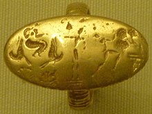 Worn gold ring with epiphany scene: at right a worshipper invokes a tree, at left a goddess with two birds appears in the air. The standing central figure may be a god. P1010617 crop (cropped).jpg