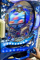 A modern, electronic pachinko machine in a Tokyo parlor