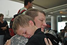 A young boy says goodbye to his dad before the father's deployment Seth Singleton.jpg