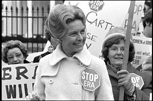 Phyllis Schlafly wearing a "STOP ERA" badge at an anti-ERA rally on February 4, 1977. Activist Phyllis Schafly wearing a "Stop ERA" badge, demonstrating with other women against the Equal Rights Amendment in front of the White House, Washington, D.C. (42219314092).jpg