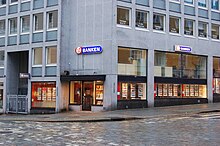 Image of a shop in the first floor of an urban building.