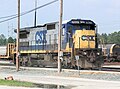 A CSX C40-8 in the YN2 "Bright Future" color scheme rests inside a railroad yard in Florida.