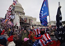 A crowd of protestors moving towards the Capitol building.