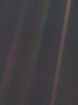 Image 17 Pale Blue Dot Photo credit: NASA/JPL Pale Blue Dot is the name given to this 1990 photo of Earth taken from Voyager 1 when its vantage point reached the edge of the Solar System, a distance of roughly 3.7 billion miles (6 billion kilometres). Earth can be seen as a blueish-white speck approximately halfway down the brown band to the right. The light band over Earth is an artifact of sunlight scattering in the camera's lens, resulting from the small angle between Earth and the Sun. Carl Sagan came up with the idea of turning the spacecraft around to take a composite image of the Solar System. Six years later, he reflected, "All of human history has happened on that tiny pixel, which is our only home." More selected pictures