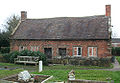 Pair of 17th-century almshouses in churchyard