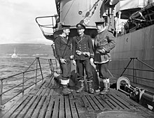 Members of a boarding party from Matane which accepted the surrender of a German submarine depot ship off the coast of Norway, seen aboard a surrendered German submarine, in Loch Eriboll, Scotland, May 1945 HMCSMataneCrewmenOnUboatMay1945.jpg