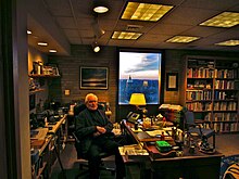 Theodore Hesburgh sitting at his desk