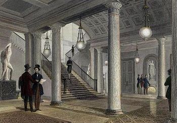 The hall of the club in 1841. The statue of Venus can be seen in its present position on the far wall, but the two statues seen on either side of the staircase were later removed. Athenaeum-Lobby.jpg