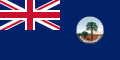 This is the SVG vector image of the flag and government ensign of the Colony of Seychelles from 1903 to 1961. It is recommended to create a new SVG vector image based on this SVG. Just change the background color from blue to the same red as the Union Flag in the upper left corner. In addition, the black edge around the round badge should be removed.