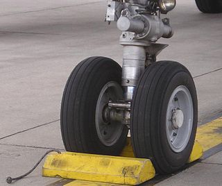 <span class="mw-page-title-main">Wheel chock</span> Wedge used to stop object from rolling