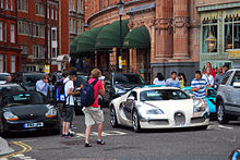 Car spotters around a Bugatti Veyron outside Harrods in Knightsbridge, London, England Carspotters.jpg