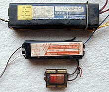 Several American magnetic ballasts for fluorescent lamps. The top is a rapid start series autoregulator ballast for two 30-40 W lamps. The middle is a preheat reactor ballast for a single 30-40 W lamp while the bottom ballast is a simple inductor used with a 15 W preheat lamp. Magnetic Ballasts 1.jpg