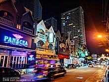 Several bars along Thappraya Road, Jomtien with a passing Songthaew