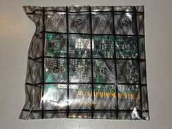 A network card inside an antistatic bag, a bag made of a partially conductive plastic that acts as a Faraday cage, shielding the card from ESD. Antistatic bag.jpg