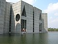 Image 22Jatiyo Sangsad Bhaban is the National Assembly Building of Bangladesh, located in the capital Dhaka. It was created by architect Louis I. Kahn and is one of the largest legislative complexes in the world. It houses all parliamentary activities of Bangladesh. This photo offers a close view of a section of the parliament building. Photo Credit: justinstravels