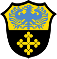 Gemeinde Merching Schild geteilt; oben in Gold ein blauer Adler, unten in Schwarz ein goldenes Kleeblattkreuz.