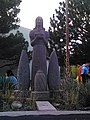 sculpture of a woman surrounded by cacti